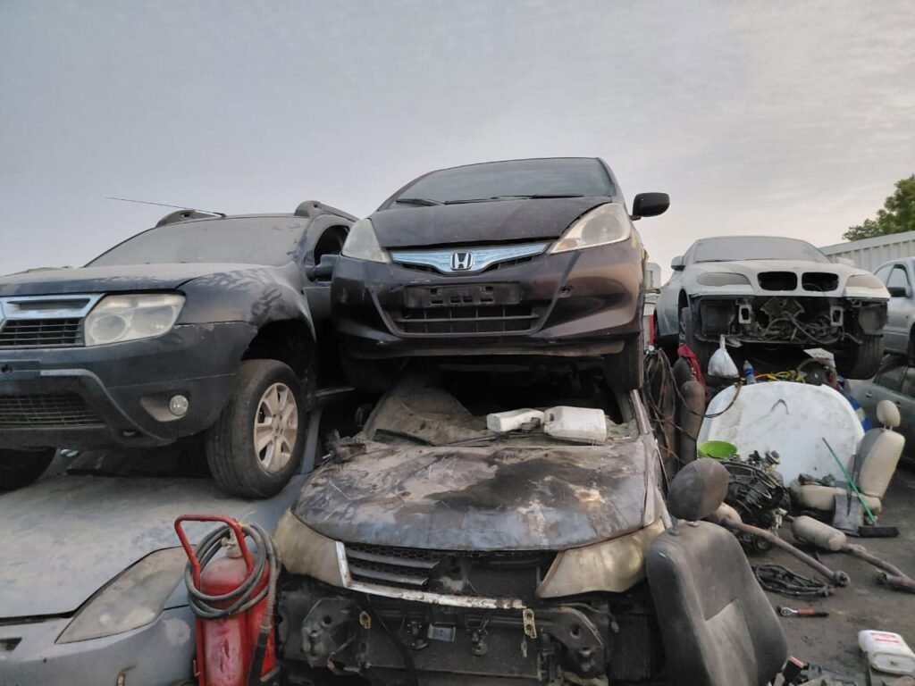 Scrap silver Lexus LS sedan collected for pickup in a UAE yard