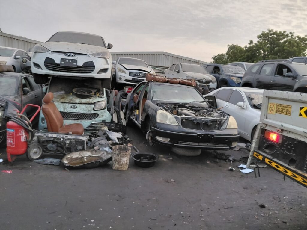 Scrap vehicles being processed at a scrap buyer yard in Dubai